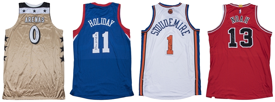 Lot of (4) Signed NBA Game Jerseys - 2011 Stoudemire Knicks Home Jersey, 2014 Noah Bulls Road Jersey, 2012 Holiday 76ers Blue Jersey & 2006-07 Arenas Wizards Gold Jersey (Player LOAs & JSA) 